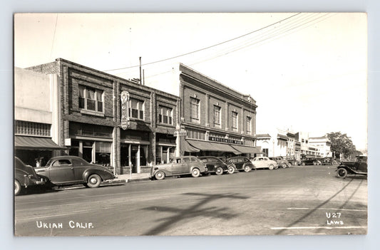Ukiah California downtown street scene showing PG and E building, Montgomery Ward storefront, and rows of 1940s automobiles parked along wide main street