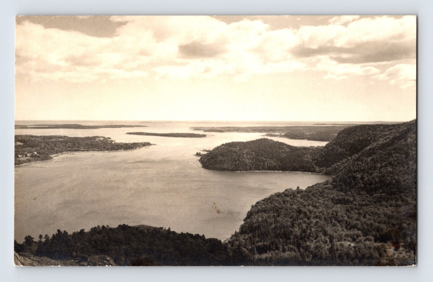 1963 RPPC view of Somes Sound on Mount Desert Island Maine showing coastal waterway with surrounding wooded hills and layered shoreline in soft light