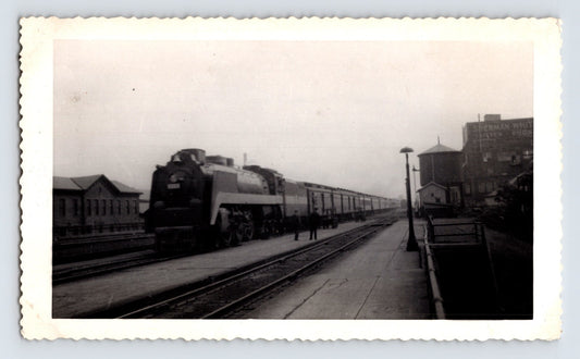 Wabash Railroad 4-6-4 steam locomotive with passenger train at Fort Wayne Indiana depot platform, 1947 snapshot photograph
