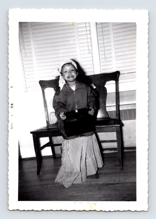 Halloween girl trick or treat bucket headscarf striped skirt indoor snapshot 1958 vintage black and white photo