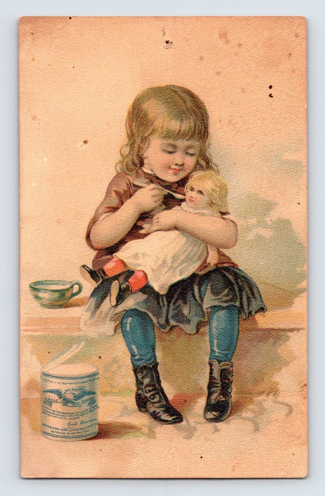 Gail Borden Eagle Brand Condensed Milk Victorian trade card featuring a young girl feeding a doll beside a can of condensed milk.