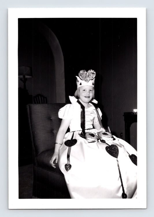 Girl Queen of Hearts costume Alice in Wonderland chair indoor Halloween snapshot photo 1960s