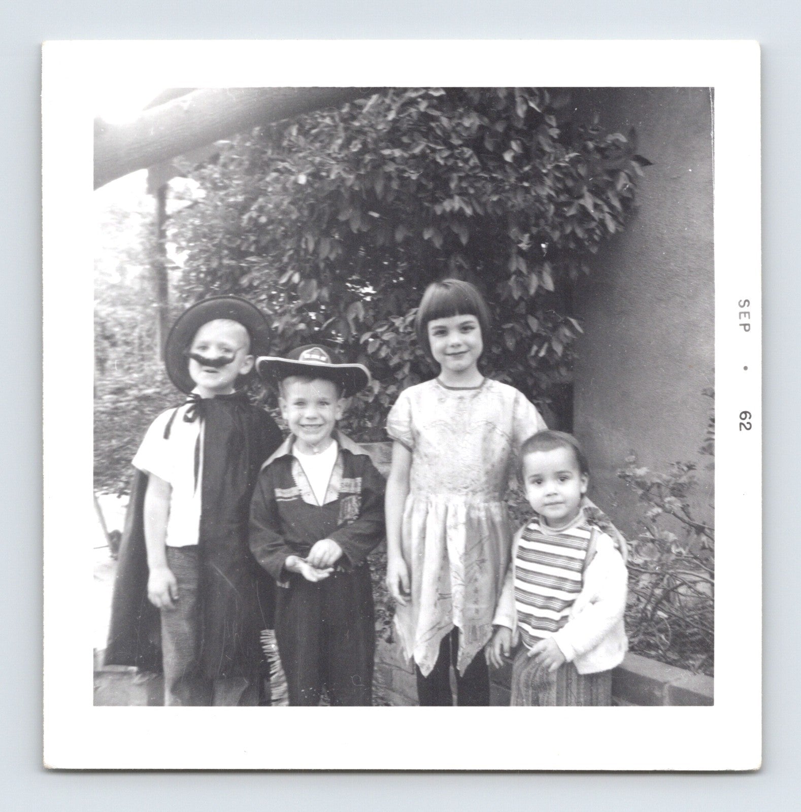 Halloween 1961 children costumes cowboy mask group outdoor snapshot vintage photo