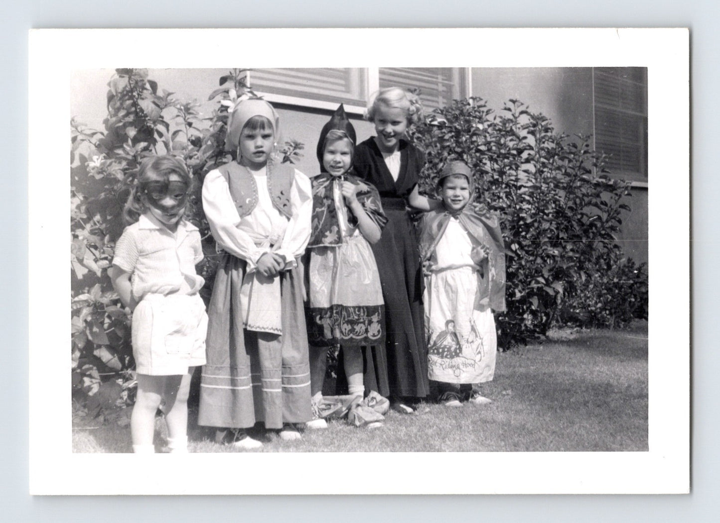 Halloween photo children costumes group yard masks capes 1960s snapshot kids dressed up outdoors house scene 3.25 x 4.5