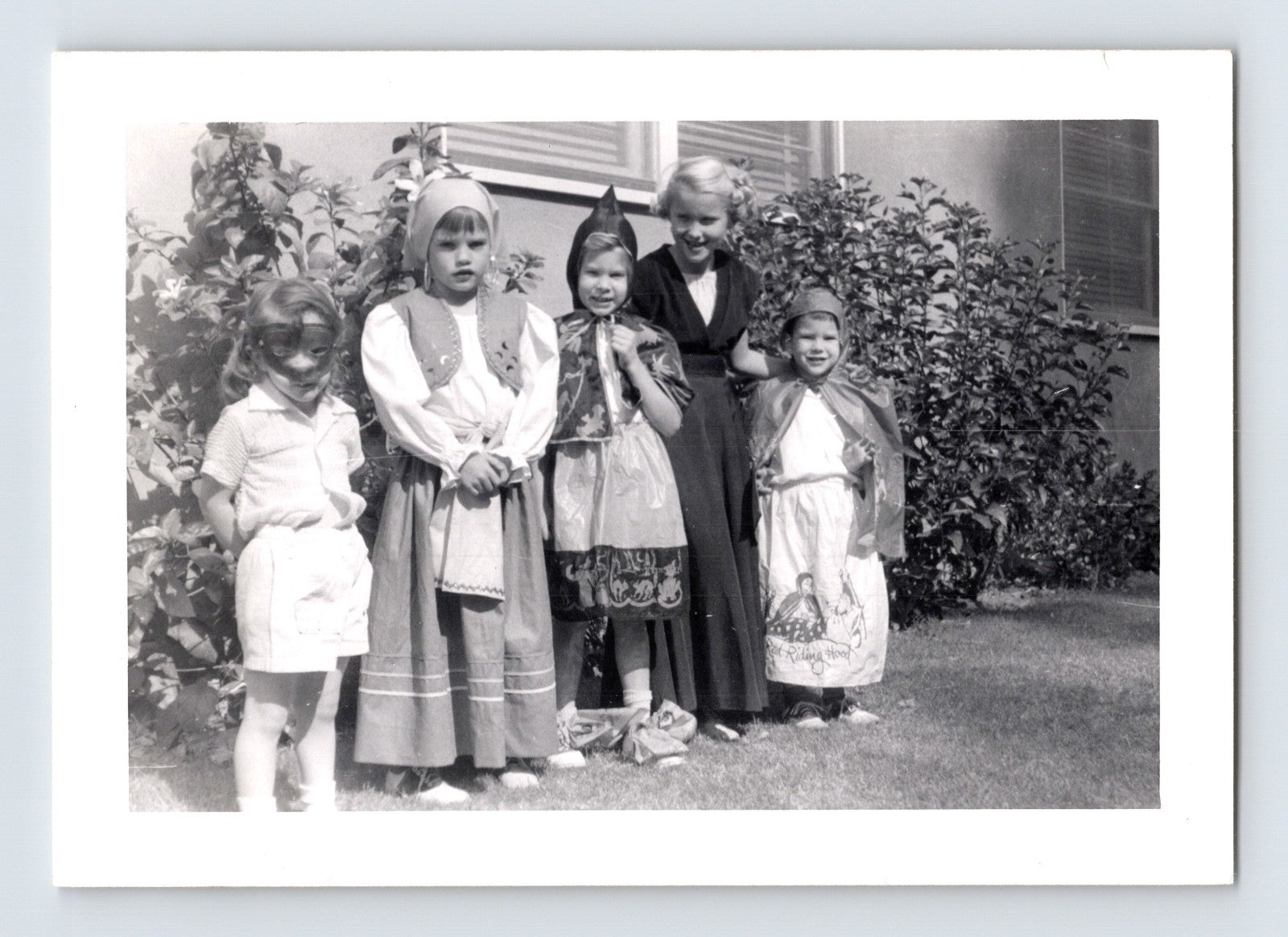Halloween photo children costumes group yard masks capes 1960s snapshot kids dressed up outdoors house scene 3.25 x 4.5