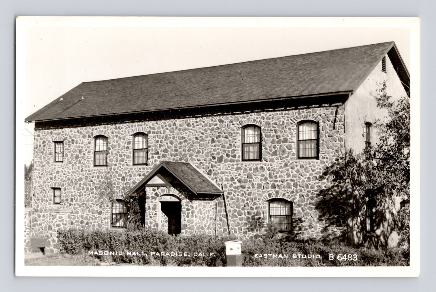 Stone Masonic Hall building in Paradise California real photo postcard showing two story masonry structure with central entrance and arched windows