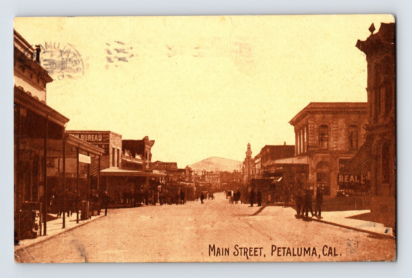 Vintage photograph of Main Street in Petaluma, California with historical buildings and pedestrians.