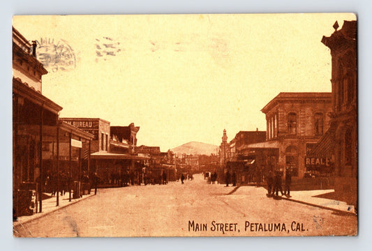 Vintage photograph of Main Street in Petaluma, California with historical buildings and pedestrians.