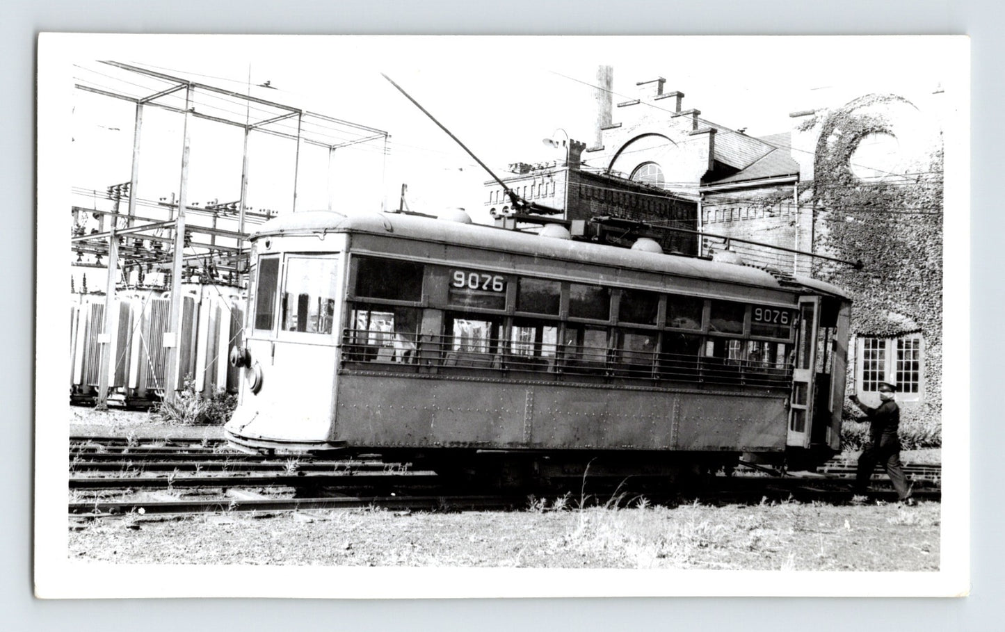 Black-and-white photograph of Stark Electric Railway streetcar number 9076 in Canton, Ohio, showing an interurban trolley beside electrical infrastructure and rail yard tracks.