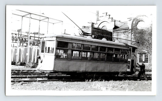 Black-and-white photograph of Stark Electric Railway streetcar number 9076 in Canton, Ohio, showing an interurban trolley beside electrical infrastructure and rail yard tracks.