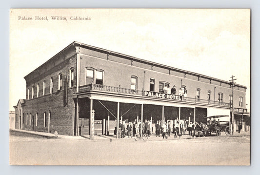 Willits California Palace Hotel two story brick building with crowd and early automobiles 1910s post