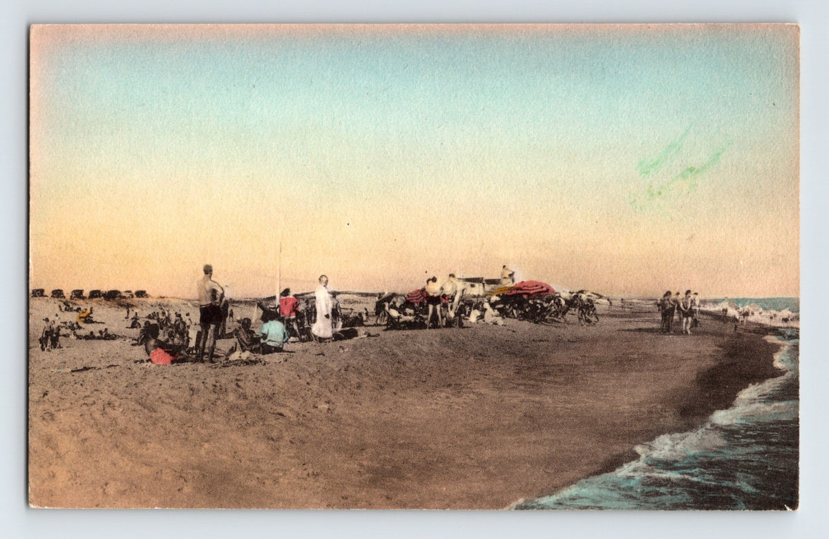 Hand colored postcard of Cooper's Neck Beach in Southampton Long Island New York with beachgoers, umbrellas, and shoreline surf