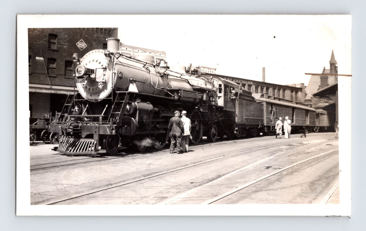 Milwaukee Road 4-6-2 steam locomotive at depot platform with passenger cars Wisconsin 1939