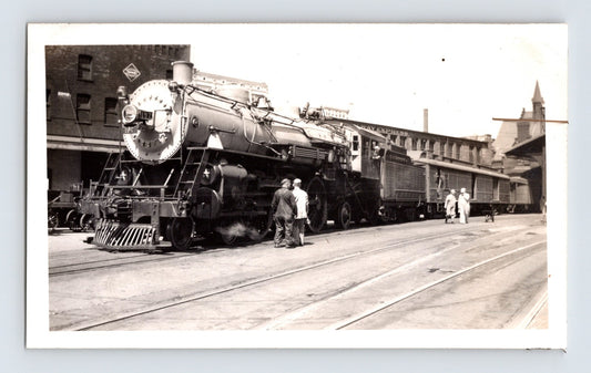 Milwaukee Road 4-6-2 steam locomotive at depot platform with passenger cars Wisconsin 1939