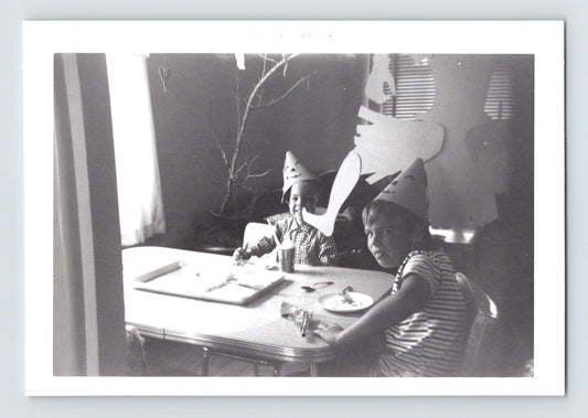 Halloween children table party hats paper masks witch decoration 1969 vintage snapshot black and white photo