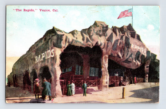 Venice California Rapids amusement attraction building with artificial rock façade and American flag, early 1910s postcard
