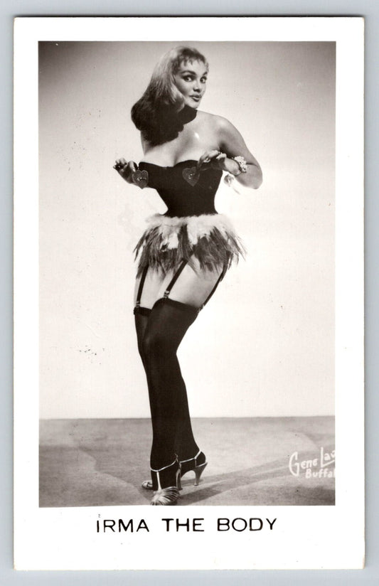 Irma The Body burlesque performer posing in corset, feathered skirt and stockings in 1950s studio portrait
