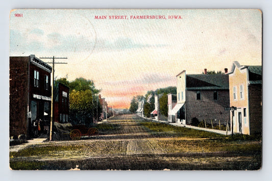 Colorized streetscape view of Main Street with storefronts and dirt road in Farmersburg Iowa 1909 postcard