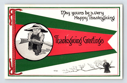 Thanksgiving 1920s postcard with little boy holding rifle in pennant design with turkey illustration and holiday greeting text