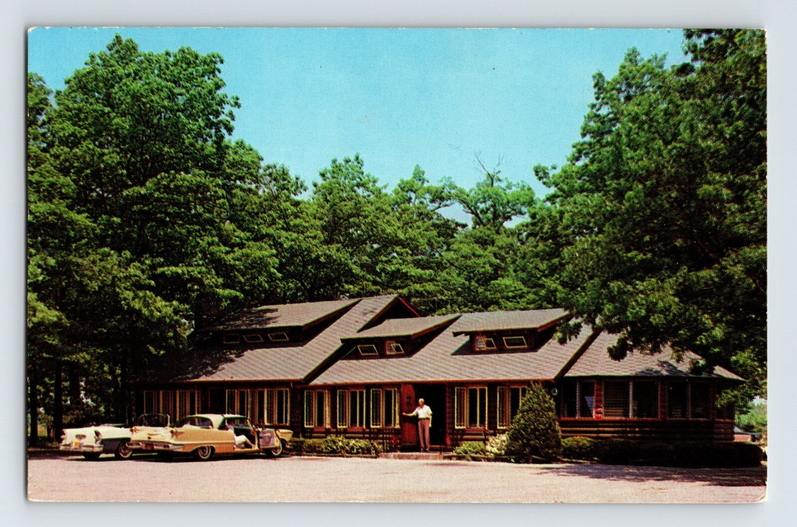 Port Jefferson Station Long Island New York Wagon Wheel motel building 1960s postcard with car and wooded setting