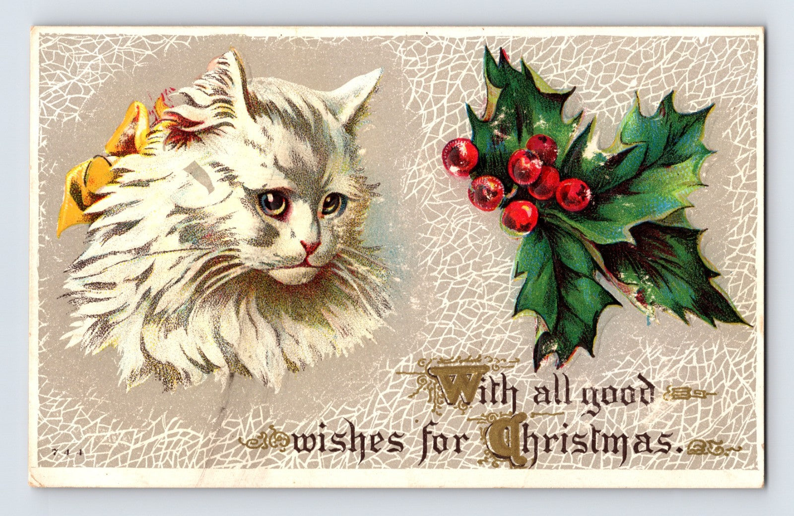 White longhair cat beside holly berries in embossed Christmas postcard with silver crackle background and handwritten holiday greeting on divided back.