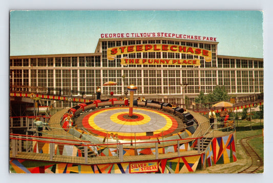 New York City Coney Island Steeplechase Park Silver Streak ride with colorful circular platform and pavilion 1960s postcard