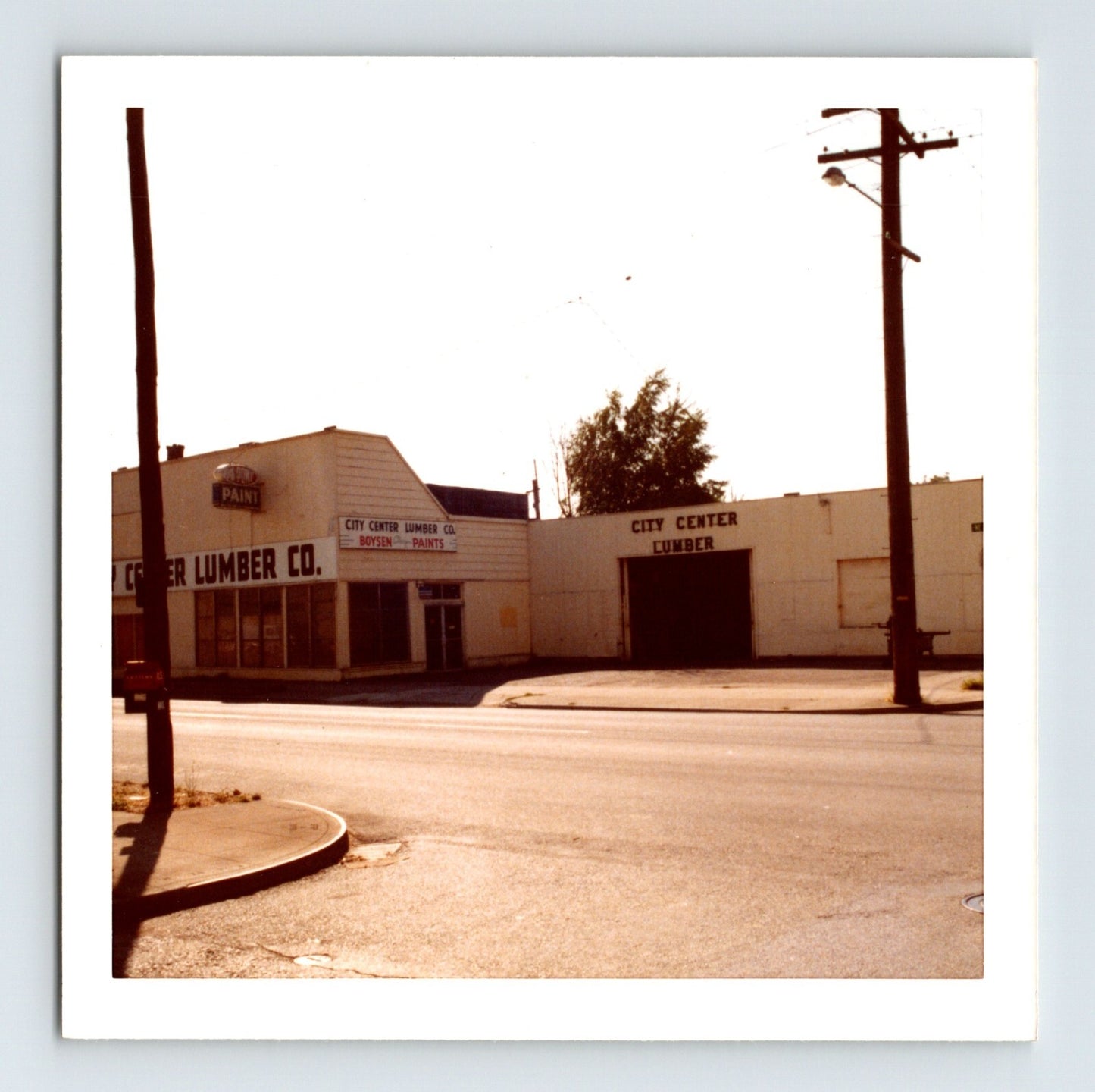 Portland Oregon City Center Lumber storefront photo with street corner buildings and utility poles