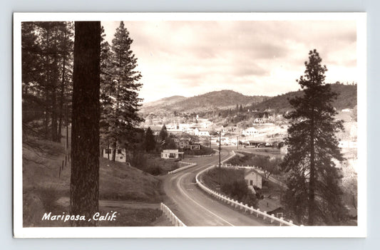 1950s Mariposa California Southern Entrance Road curving highway view with pine trees hillside homes and Sierra foothills