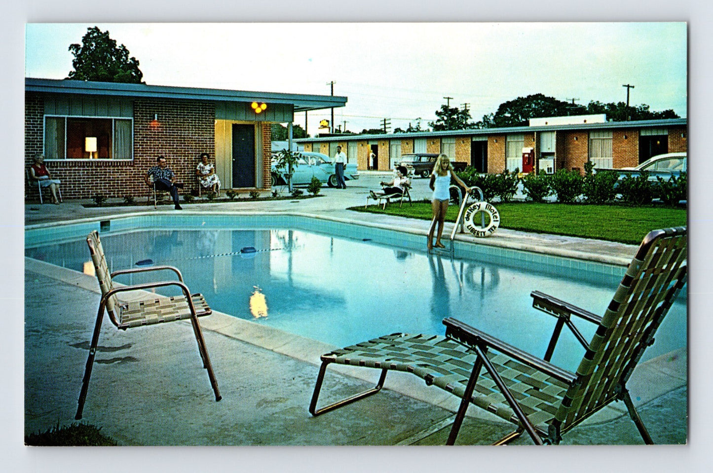Liberty Texas Del Rey Motel 1960s postcard showing roadside motel with swimming pool lounge chairs guests and parked cars along Highway 90