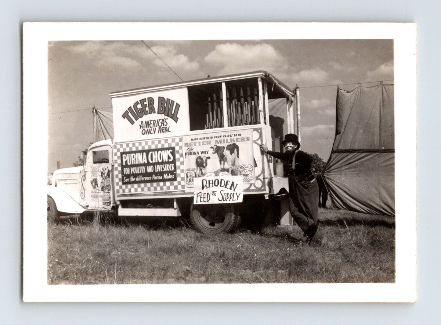 Black and white photograph of Tiger Bill’s Wild West Circus truck with clown Rube Roy 1952