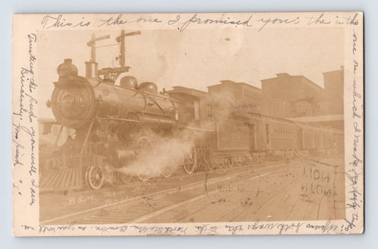 Sepia real photo postcard of Boston and Maine Railroad steam locomotive with passenger cars at station platform in Boston Massachusetts 1907