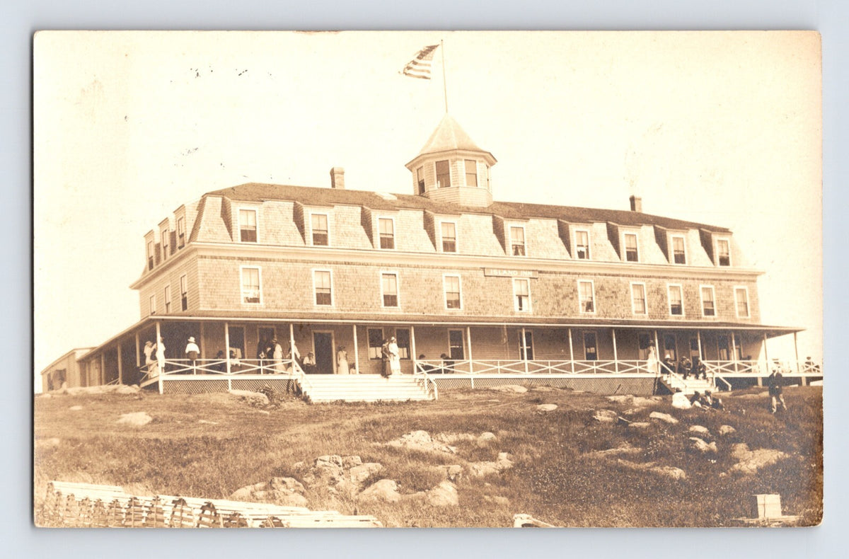 Monhegan Maine Island Inn seaside hotel with porch guests and lobster traps RPPC 1922