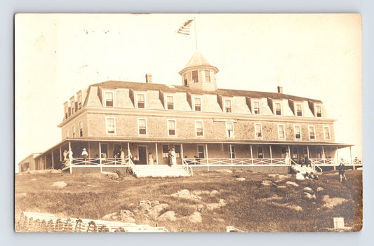 Monhegan Maine Island Inn seaside hotel with porch guests and lobster traps RPPC 1922