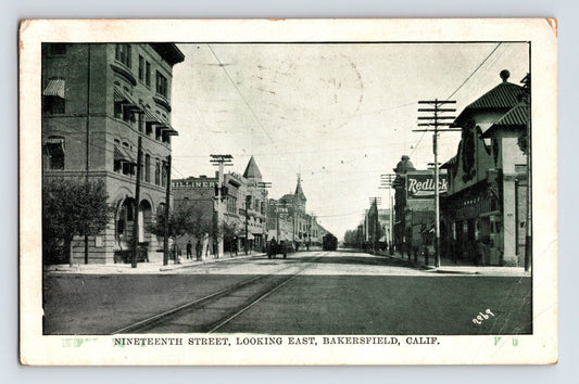 Bakersfield California 19th Street looking east downtown storefronts streetcar tracks 1910 postcard