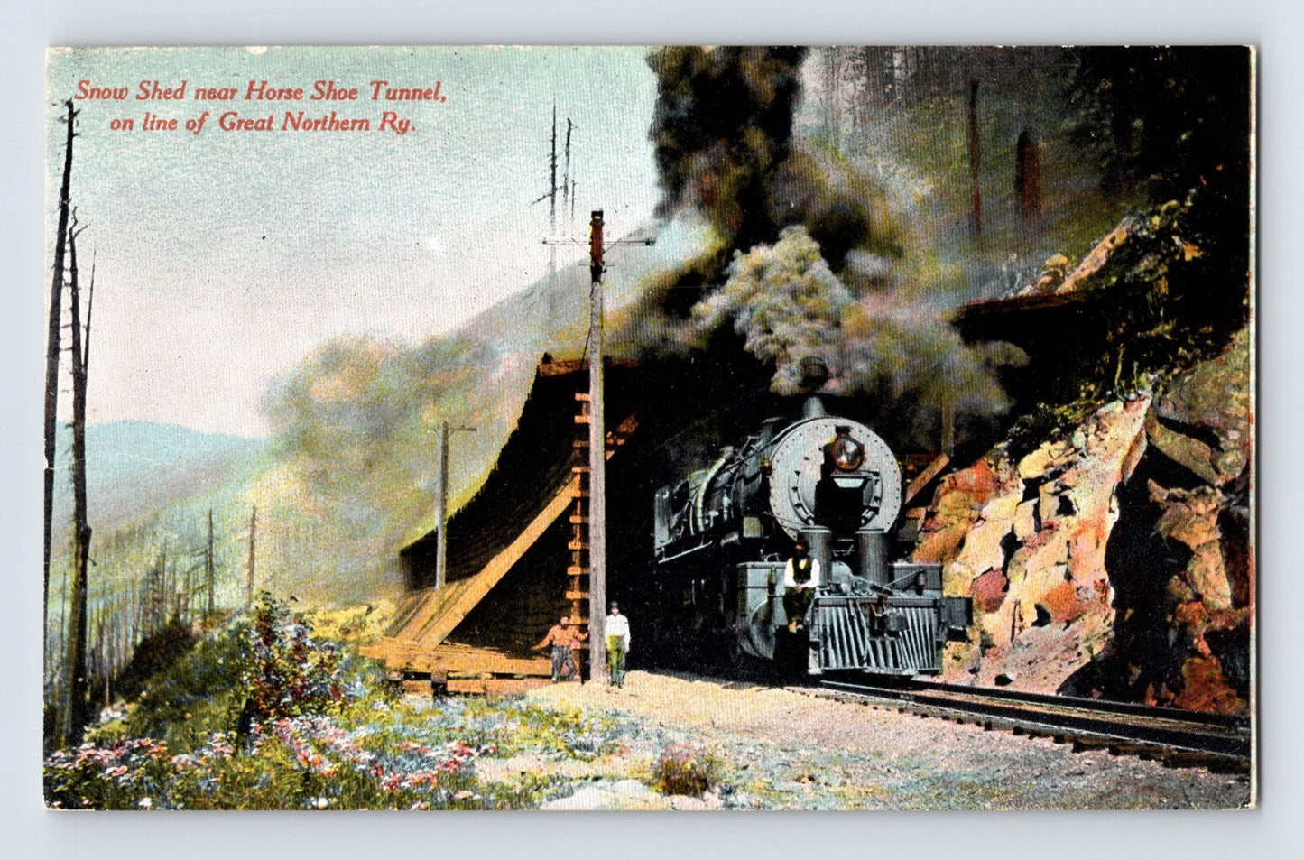 1910s postcard of Great Northern Railway steam locomotive emerging from snow shed near Horse Shoe Tunnel in Washington State