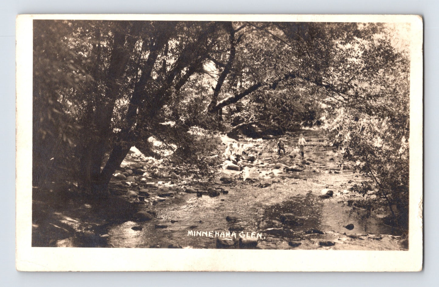 Minnesota Minnehaha Glen 1910s real photo postcard showing wooded creek with rocks shaded by trees natural landscape scene