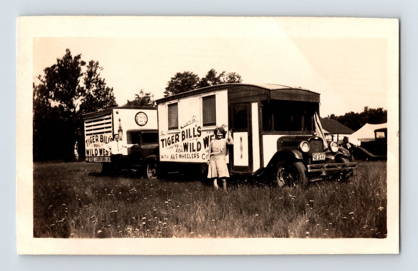 Tiger Bill’s Wild West Circus truck with performer posing in field 1950s snapshot