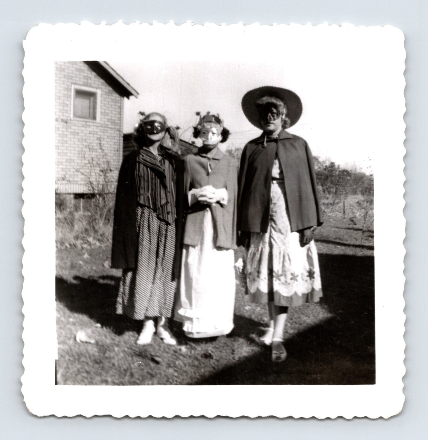 Halloween women masks capes costumes backyard house mid century snapshot three women posing outdoors 3.5 x 3.5 photo
