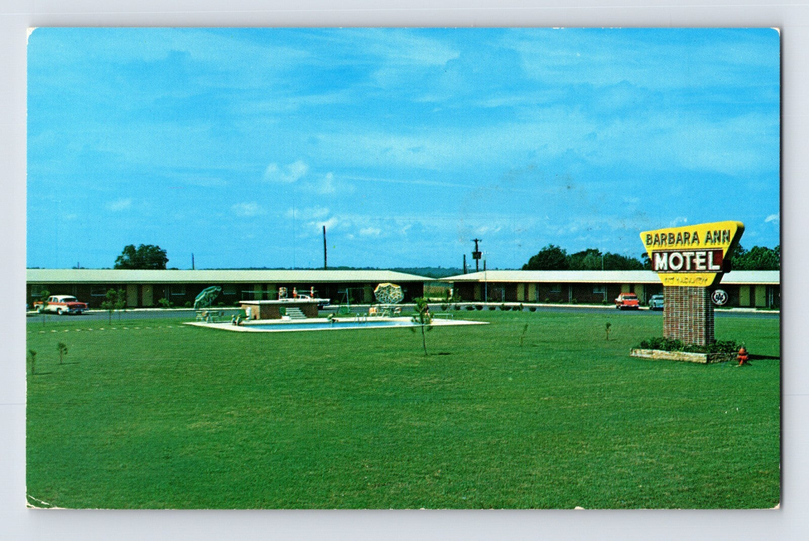 Chrome postcard of Barbara Ann Motel in Ozark Alabama showing roadside sign, swimming pool, and single-story motor court along Highway 231