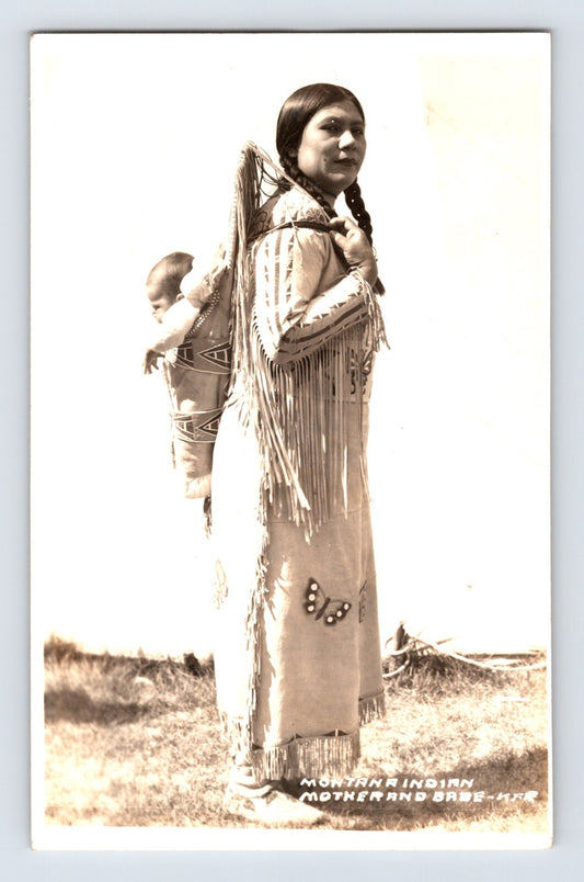 Postcard front showing Native American woman carrying a child in cradleboard, studio captioned Montana Indian K. F. Roahan photo, 1940s