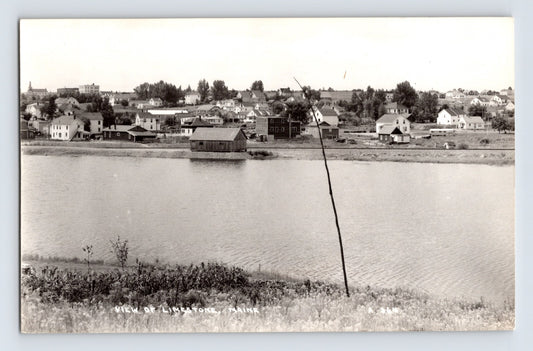 Limestone Maine shoreline view across calm water toward small town buildings 1950s real photo postcard