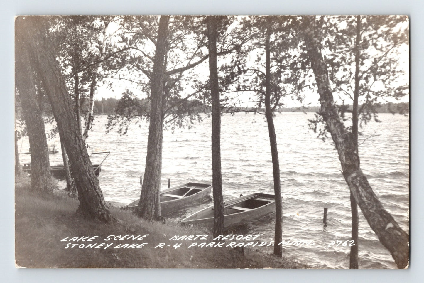 Park Rapids Minnesota Bartz Resort Stoney Lake RPPC postcard with rowboats along wooded shoreline
