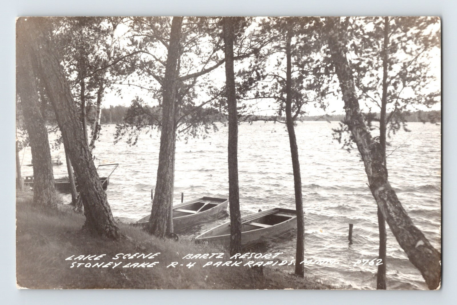 Park Rapids Minnesota Bartz Resort Stoney Lake RPPC postcard with rowboats along wooded shoreline