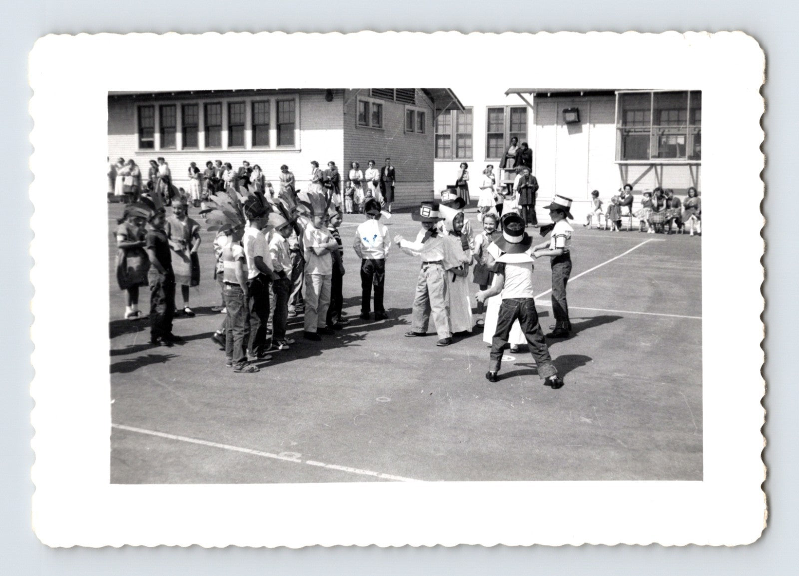 School Thanksgiving play children Pilgrim and Native American costumes playground 1950s photo