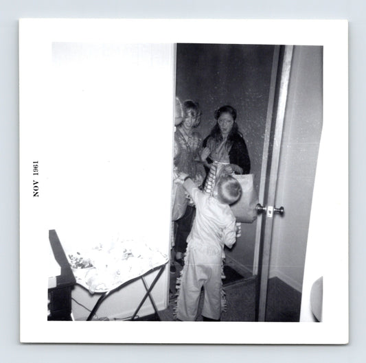 Halloween trick or treat child doorway candy exchange November 1961 snapshot costume home interior 3.5 x 3.5 photo