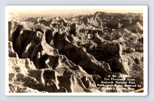 1930s South Dakota Badlands Hell Ten Thousand Acres real photo postcard showing eroded rock formations and rugged canyon landscape