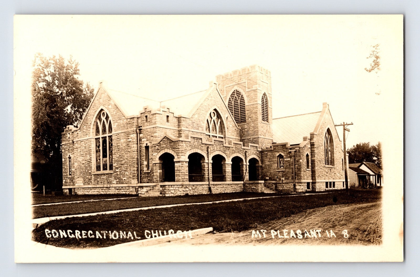 Mount Pleasant Iowa Congregational Church real photo postcard featuring large stone Gothic Revival church building and tower.