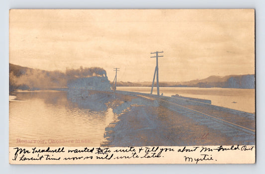 Real photo postcard of railroad train crossing reservoir causeway in Cheshire Massachusetts with 1906 postmark and handwritten message
