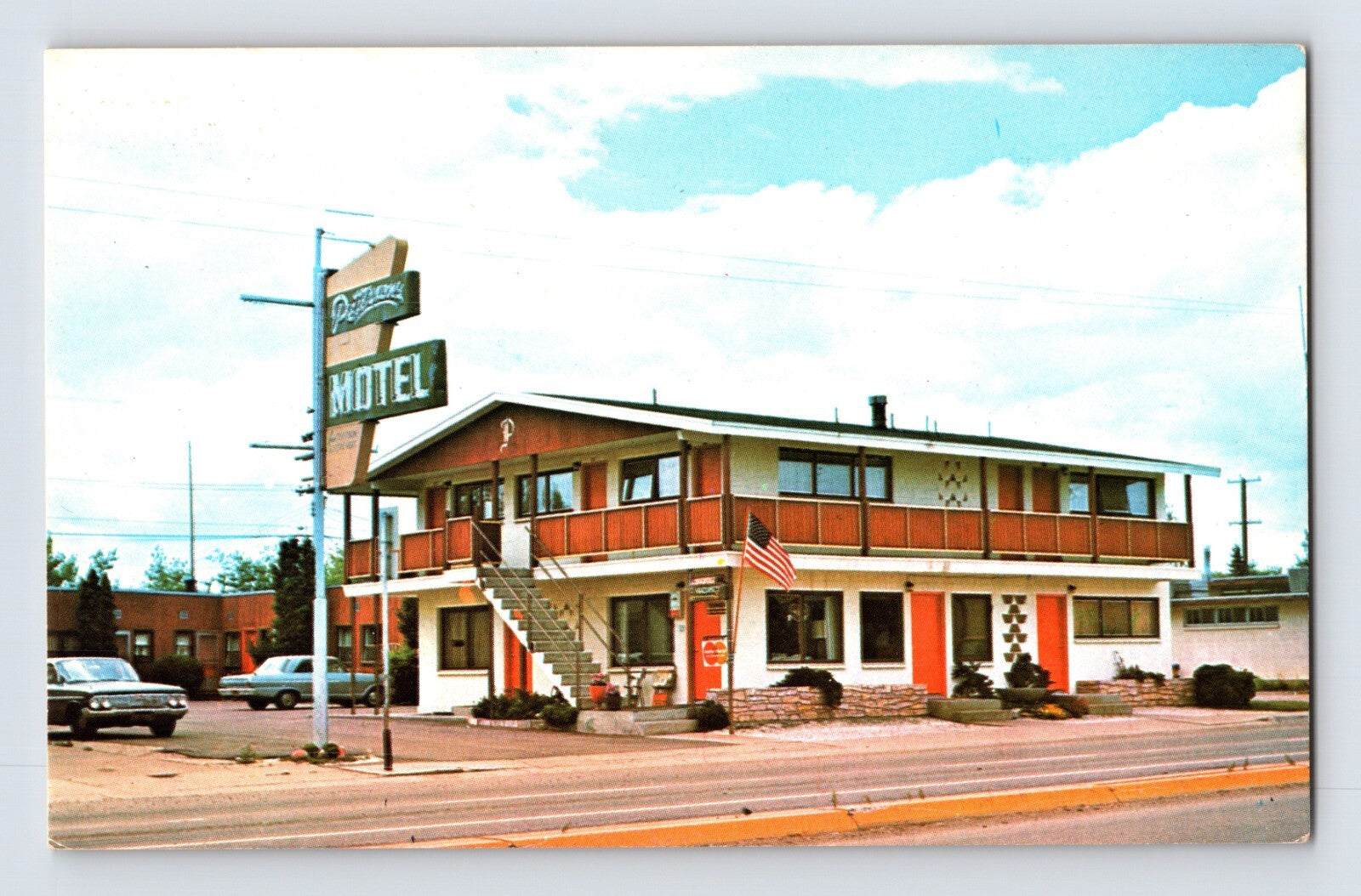 Street view of Petersons Motel in Kalispell Montana with exterior staircase roadside sign and parked cars