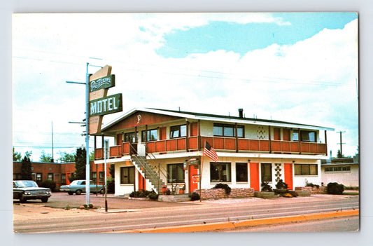 Street view of Petersons Motel in Kalispell Montana with exterior staircase roadside sign and parked cars